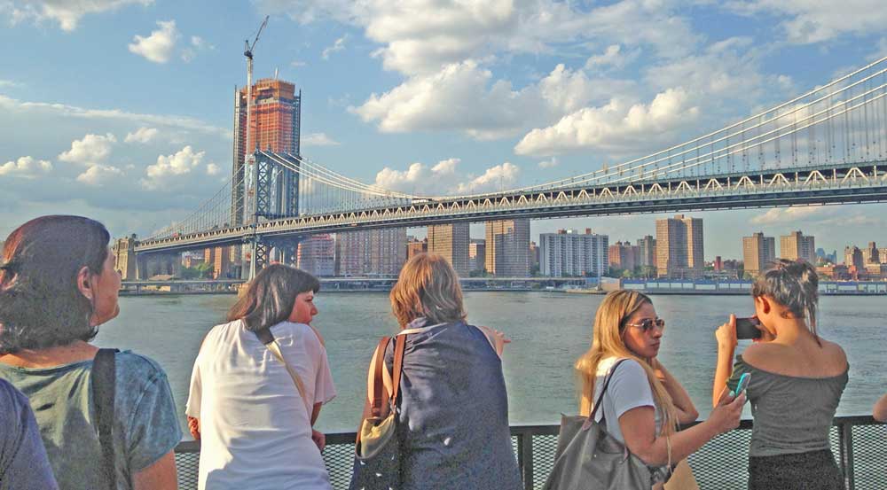 People looking at skyline of view and Manhattan Bridge.