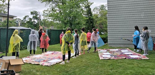 group of kids participating in spray paint class