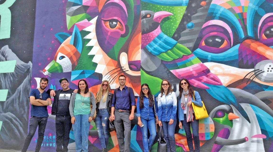 Tour group stands in front of artwork in Bushwick, Brooklyn.