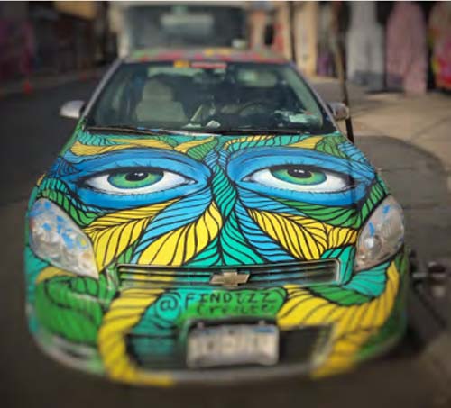 automobile covered in spray art