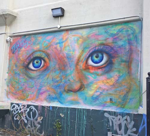 artwork on wall of eyes and bright colors