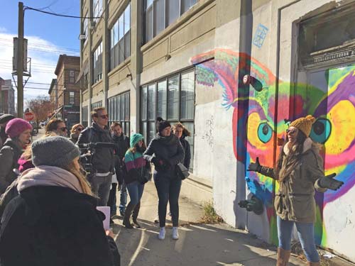 graffiti artist addressing a tour group
