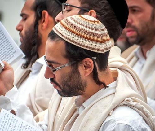 man dressed in white praying