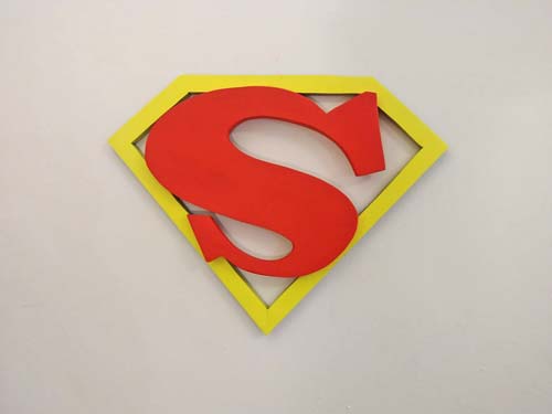 wooden sculpture of Superman logo
